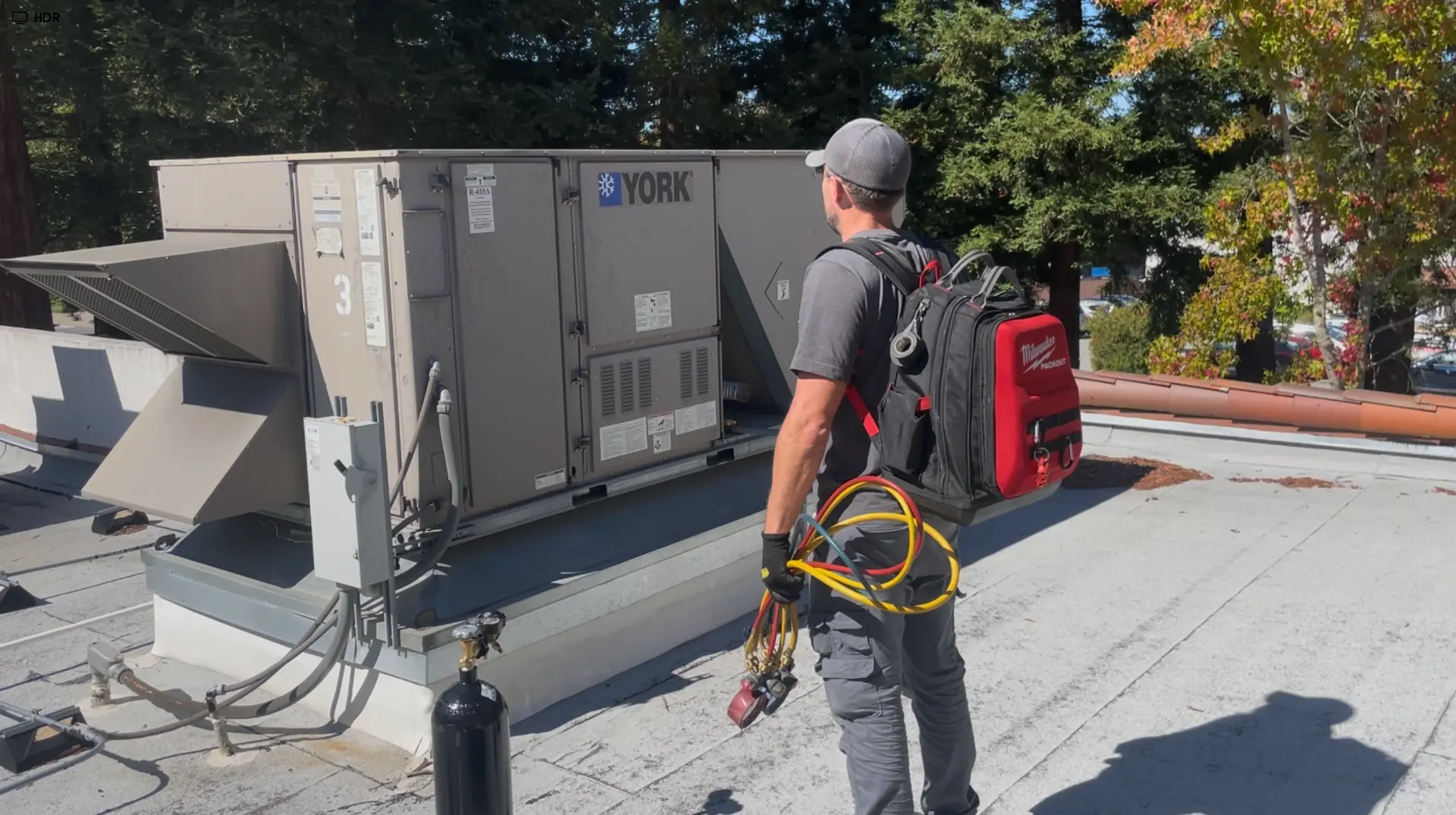 SavvyTeks owner servicing a rooftop commercial HVAC unit